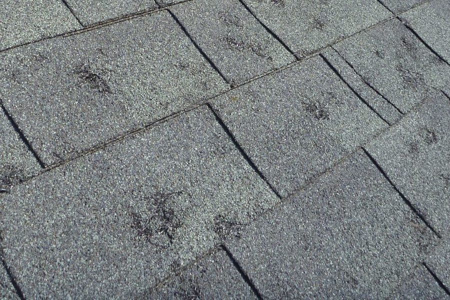 Emergency roof tarping over storm damage on an Indianapolis area home